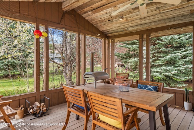 sunroom with beamed ceiling, ceiling fan, and outdoor dining area