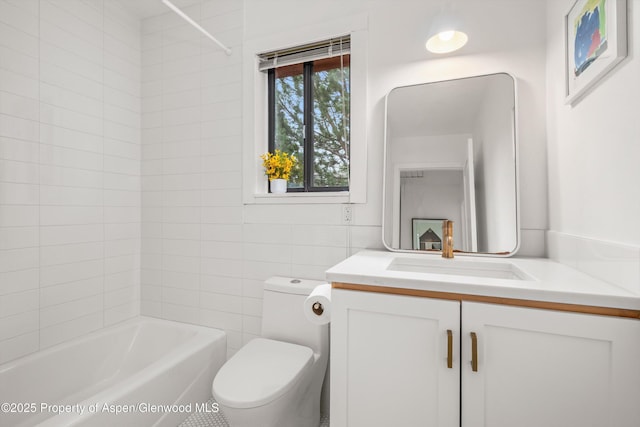 bathroom featuring toilet, tile walls, tub / shower combination, and vanity