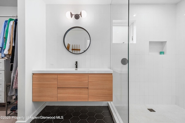 bathroom featuring tile patterned floors, walk in shower, and vanity