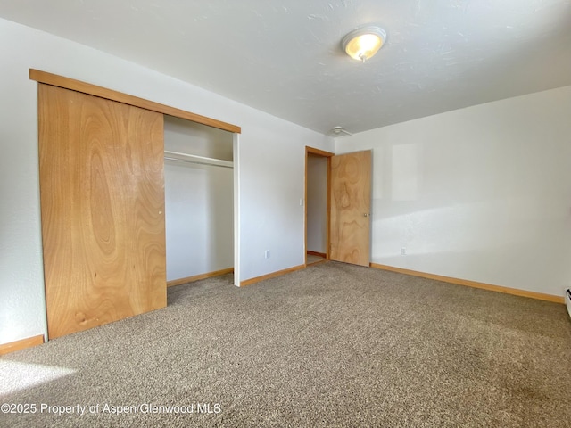 unfurnished bedroom with a closet and carpet floors