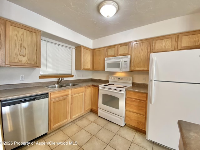 kitchen with sink, light tile patterned floors, and white appliances