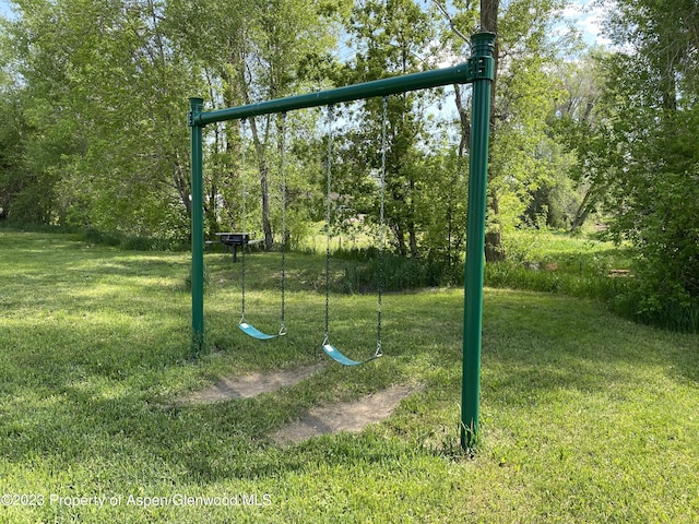 view of playground with a lawn