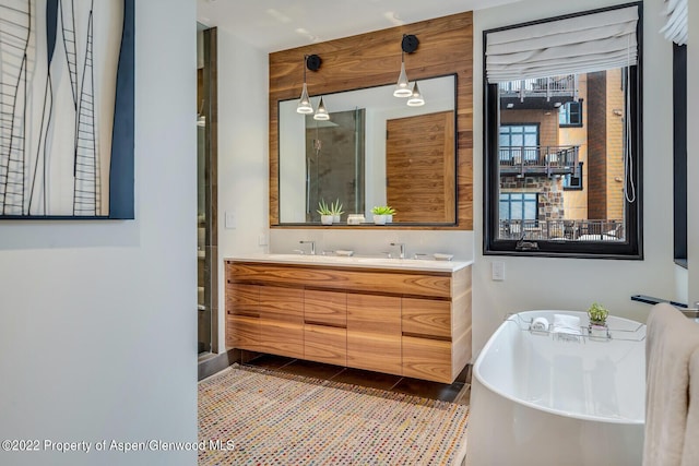 bathroom featuring tile patterned floors, plus walk in shower, and vanity