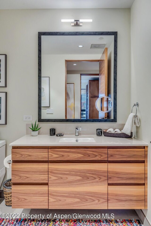 bathroom featuring vanity and toilet