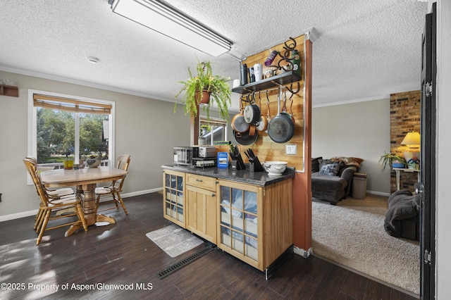 1617 W 7th St, Rifle, CO 81650 - kitchen featuring a textured ceiling, crown molding, dark wood finished floors, and dark countertops