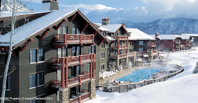 snow covered property with a mountain view