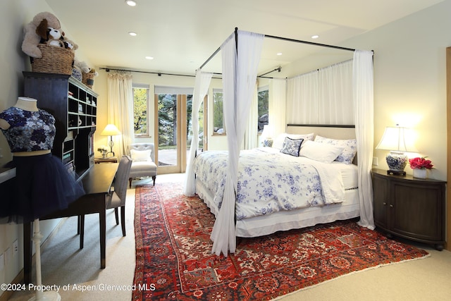 carpeted bedroom with access to exterior