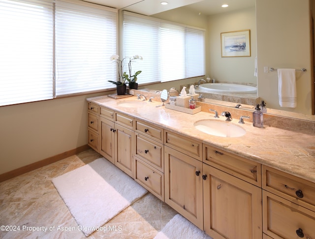 bathroom featuring vanity, a tub to relax in, a wealth of natural light, and tile patterned floors