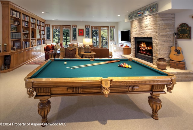 playroom featuring carpet, a stone fireplace, and billiards