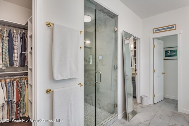 64 White Peaks Ln, Glenwood Springs, CO 81601 - full bathroom featuring a spacious closet, a stall shower, marble look tiles, and baseboards