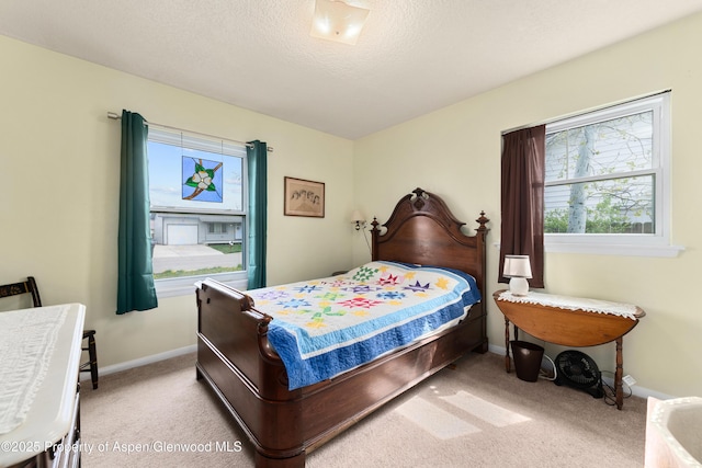 bedroom featuring carpet and baseboards