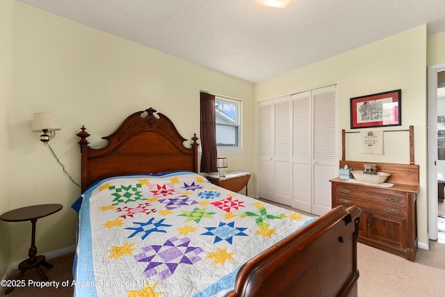 bedroom with carpet flooring, a closet, and baseboards