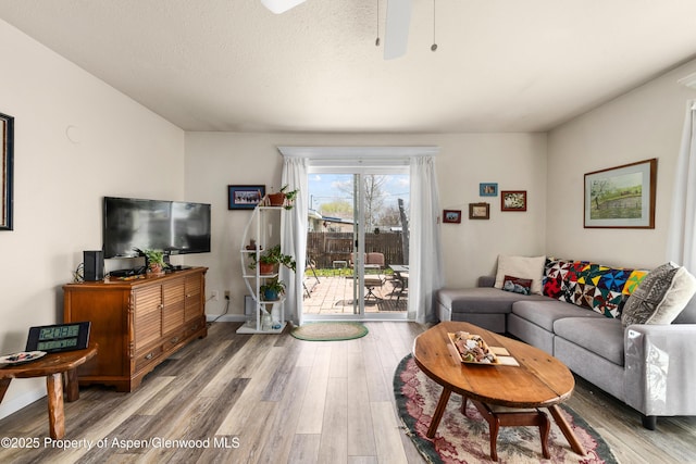 living room with light wood-style floors and ceiling fan