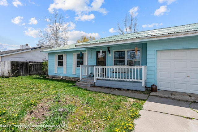 ranch-style home with a porch, a garage, and metal roof