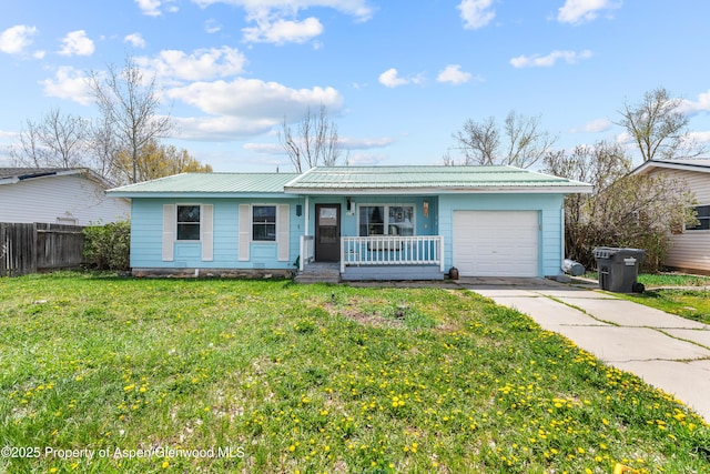 single story home with covered porch, an attached garage, driveway, and metal roof