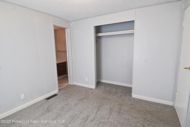 22 W Silver Bell Pl, Parachute, CO 81635 - unfurnished bedroom featuring a textured ceiling, visible vents, a closet, carpet, and ensuite bath