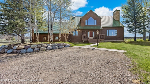 3 Red Wing Ln, Carbondale, CO 81623 - rear view of property featuring a lawn, a chimney, and metal roof