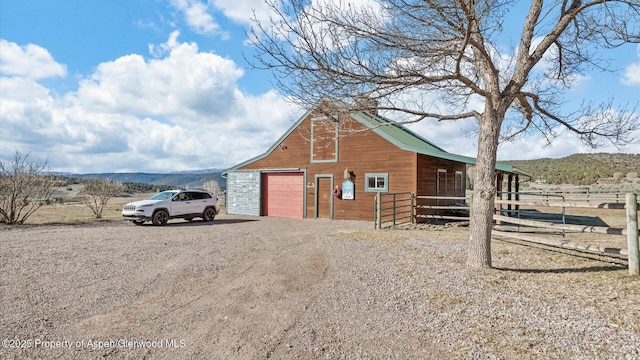 3 Red Wing Ln, Carbondale, CO 81623 - view of barn featuring driveway, a mountain view, fence, and an exterior structure
