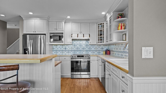 3 Red Wing Ln, Carbondale, CO 81623 - kitchen featuring open shelves, stainless steel appliances, a kitchen breakfast bar, white cabinetry, and light countertops