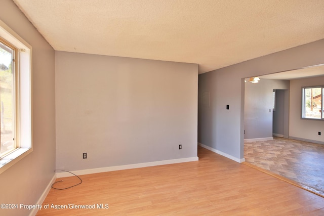 empty room featuring light hardwood / wood-style floors and a textured ceiling