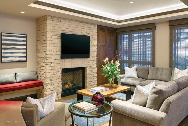 411 S Monarch St Unit H8, Aspen, CO 81611 - living room featuring a stone fireplace, a raised ceiling, wood finished floors, and recessed lighting