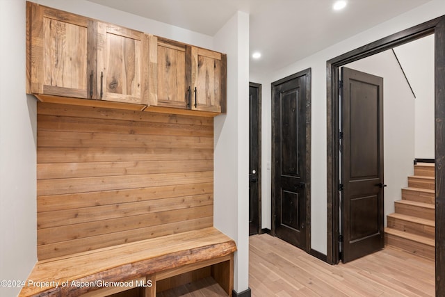 mudroom with light hardwood / wood-style floors