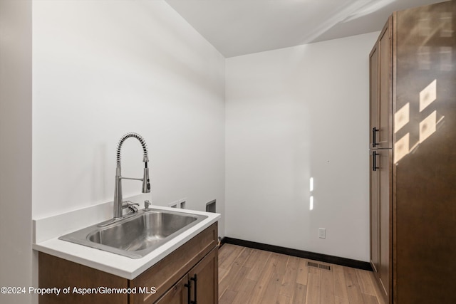 kitchen with light wood-type flooring and sink