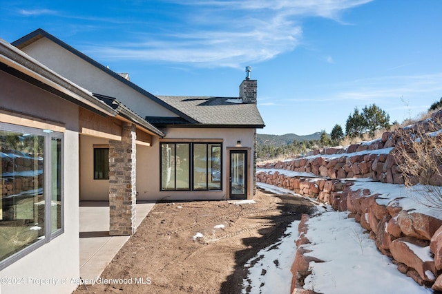 exterior space featuring a mountain view and a patio area