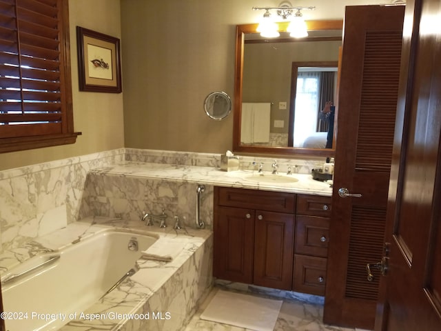 bathroom with vanity and tiled tub