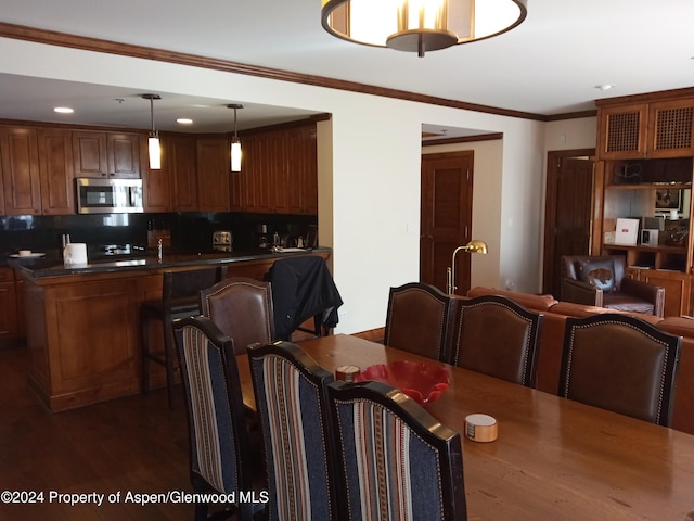 dining room featuring crown molding and dark wood-type flooring