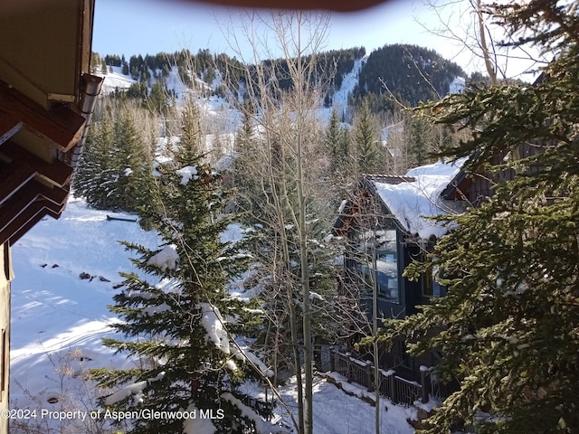 view of snow covered exterior with a mountain view