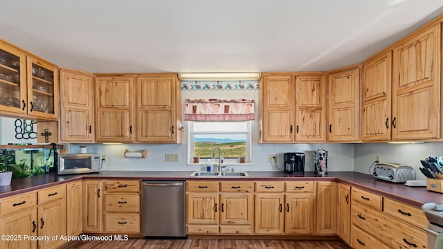 1300 Johnson Way, Craig, CO 81625 - kitchen with stainless steel appliances, dark countertops, glass insert cabinets, and wood finished floors