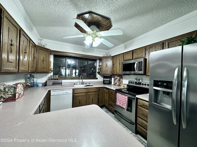 kitchen featuring stainless steel appliances, ornamental molding, and sink