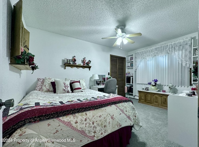 carpeted bedroom with ceiling fan and a textured ceiling