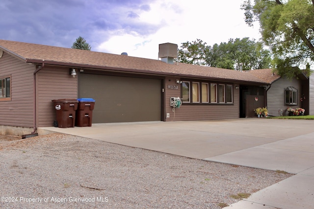 ranch-style home featuring a garage