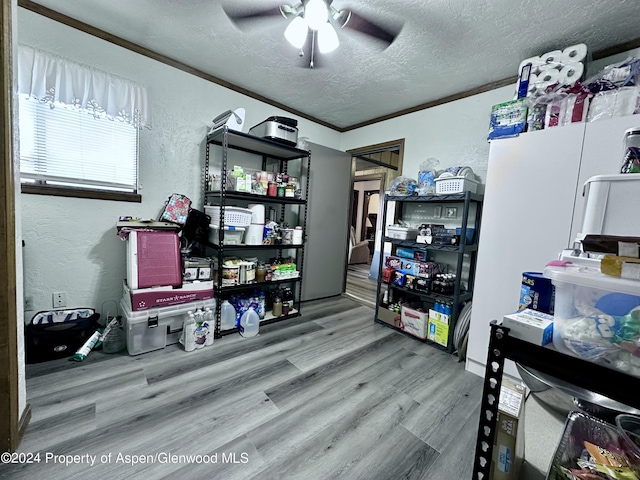 home office with a textured ceiling, hardwood / wood-style flooring, ceiling fan, and ornamental molding