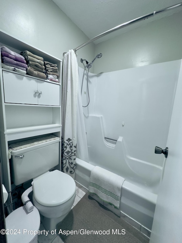 bathroom featuring shower / tub combo and toilet