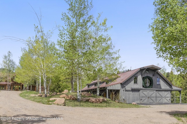 6855 Capitol Creek Rd, Snowmass, CO 81654 - view of front of property featuring driveway, a barn, a detached garage, and an outdoor structure