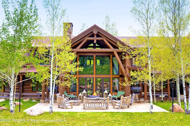6855 Capitol Creek Rd, Snowmass, CO 81654 - back of house featuring a chimney, a patio, an outdoor hangout area, and a yard