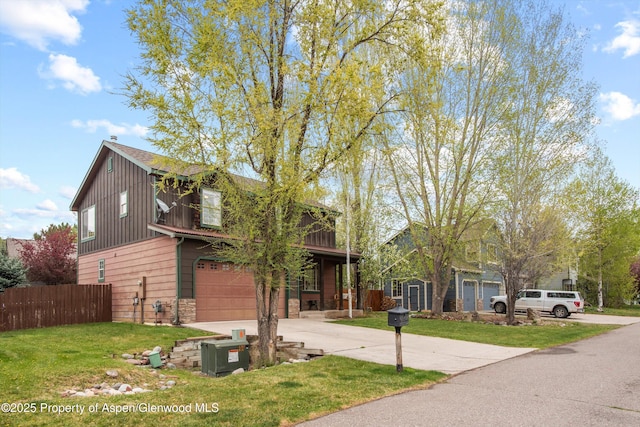 121 Ranch Creek Ln, Carbondale, CO 81623 - view of front facade featuring concrete driveway, a garage, stone siding, and board and batten siding