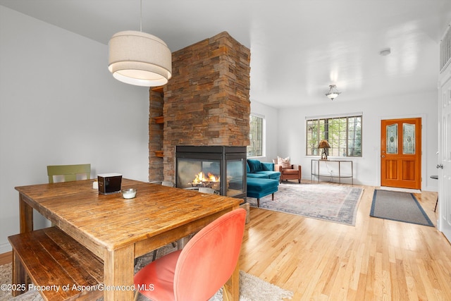 121 Ranch Creek Ln, Carbondale, CO 81623 - dining room featuring wood finished floors, a stone fireplace, and baseboards