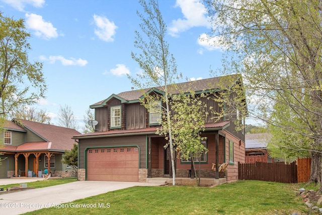 121 Ranch Creek Ln, Carbondale, CO 81623 - view of front of property featuring a porch, board and batten siding, driveway, an attached garage, and stone siding