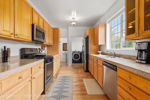 121 Ranch Creek Ln, Carbondale, CO 81623 - kitchen with appliances with stainless steel finishes, a sink, tile countertops, and washer and clothes dryer