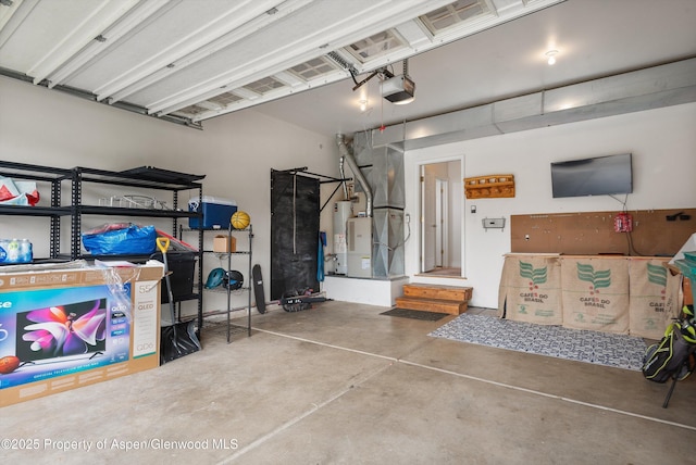 121 Ranch Creek Ln, Carbondale, CO 81623 - garage featuring a garage door opener, water heater, and heating unit