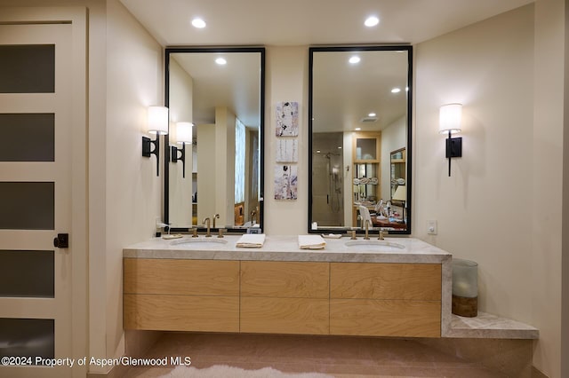 bathroom with tile patterned floors, vanity, and a shower with door