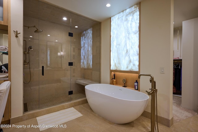 bathroom featuring tile patterned flooring and independent shower and bath