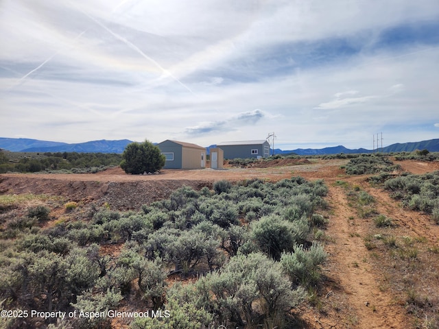 4472 V 5/10 Rd, De Beque, CO 81630 - view of yard featuring a mountain view and an outbuilding