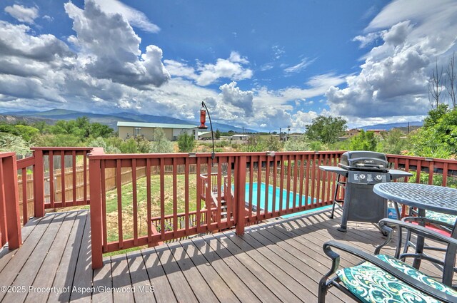 222 Creek Ct, Rifle, CO 81650 - deck featuring a grill and a swimming pool