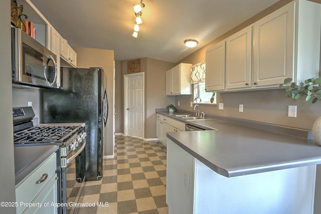 222 Creek Ct, Rifle, CO 81650 - kitchen with stainless steel appliances, white cabinets, light flooring, and a peninsula