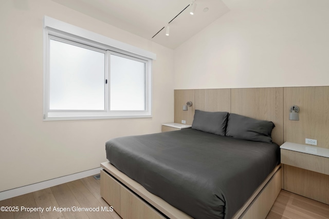 211 W Main St, Aspen, CO 81611 - bedroom with track lighting, light wood-style flooring, and lofted ceiling